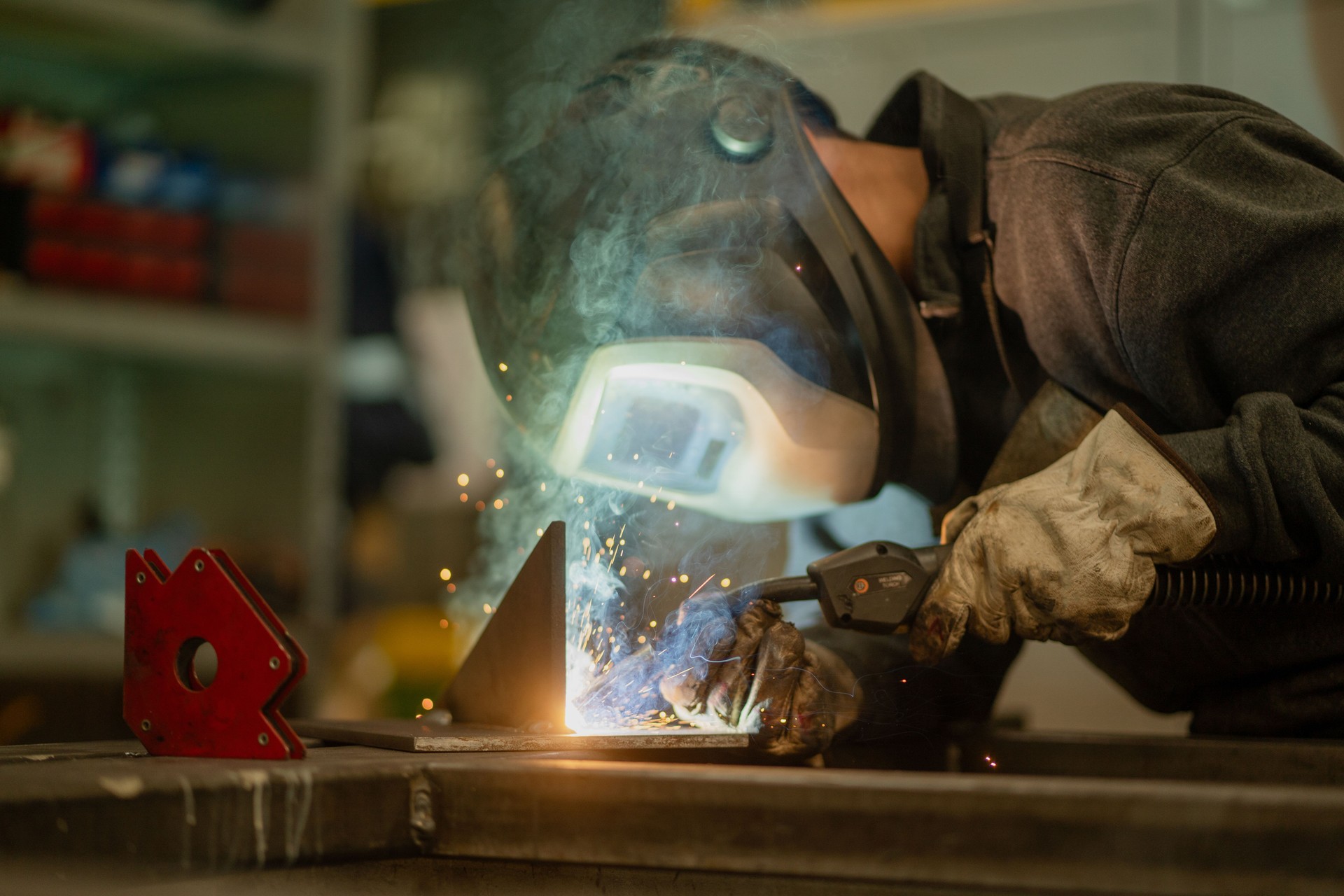 Welder works in machine shop